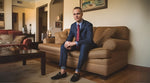 male model sitting on sofa in loafers